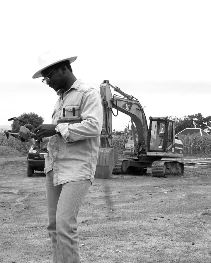 Surveying plot boundaries at an estate site in Abuja before allocation